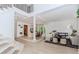 Open concept living area adjacent to stairs featuring modern furniture, bright white walls, and elegant decor at 10490 Cranchester Way, Alpharetta, GA 30022