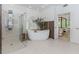 Bright bathroom boasts free standing tub, and spacious glass enclosed shower at 10490 Cranchester Way, Alpharetta, GA 30022