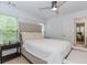 Serene main bedroom features neutral tones, a plush bed, windows for natural light, and hardwood floors at 10490 Cranchester Way, Alpharetta, GA 30022