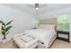 Serene main bedroom features neutral tones, a plush bed, windows for natural light, and hardwood floors at 10490 Cranchester Way, Alpharetta, GA 30022