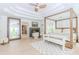 Bright main bedroom features a four-poster bed, sitting area, and fireplace at 10490 Cranchester Way, Alpharetta, GA 30022
