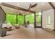 Expansive screened porch with a ceiling fan, comfortable seating, and tranquil views of the green surroundings at 10490 Cranchester Way, Alpharetta, GA 30022
