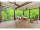 Relaxing screened porch with a ceiling fan, comfortable seating, and views of the lush landscape at 10490 Cranchester Way, Alpharetta, GA 30022