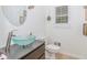 Stylish powder room features vessel sink, modern faucet and custom vanity at 10490 Cranchester Way, Alpharetta, GA 30022