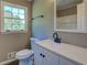 Updated bathroom features a window, modern vanity, sink, and faucet at 14721 Highway 36, Covington, GA 30014