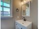 Bright bathroom with a new vanity and a mirror at 14721 Highway 36, Covington, GA 30014