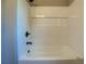 Clean bathtub with white subway tile, recessed shelf, and modern fixtures at 14721 Highway 36, Covington, GA 30014