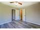 Neutral bedroom features wood-look floors, open closet, and a ceiling fan at 14721 Highway 36, Covington, GA 30014