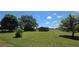 A beautiful lawn and sunny skies highlight this home with mature trees and a detached shed at 14721 Highway 36, Covington, GA 30014