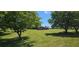 Charming single-story brick home set back on a sprawling green lawn, framed by mature trees at 14721 Highway 36, Covington, GA 30014