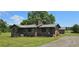 Well-maintained brick home with an established lawn, complemented by fresh flowerbeds and a detached storage building at 14721 Highway 36, Covington, GA 30014