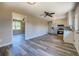 Open floorplan view of the kitchen with stainless appliances and wood-look floors at 14721 Highway 36, Covington, GA 30014