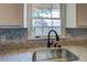 Close-up of a kitchen sink and granite countertop with a window at 14721 Highway 36, Covington, GA 30014
