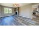 Spacious living room with gray-tone vinyl floors and a brick fireplace at 14721 Highway 36, Covington, GA 30014