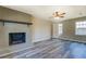 Living room with a brick fireplace and a ceiling fan at 14721 Highway 36, Covington, GA 30014