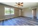 Bright living room features wood-look flooring, a ceiling fan and plenty of natural light at 14721 Highway 36, Covington, GA 30014