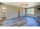 Open living room featuring new gray tone vinyl floors, a front door, and a view into the updated bathroom at 14721 Highway 36, Covington, GA 30014