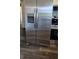Stainless steel refrigerator, featuring a water dispenser, next to the range at 14721 Highway 36, Covington, GA 30014