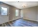 Neutral room with a window and white door features wood-look floors at 14721 Highway 36, Covington, GA 30014