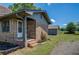 Brick home with a tidy yard, showing a side entrance and a detached building at 14721 Highway 36, Covington, GA 30014