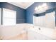 Bathroom features a bright window, a walk-in shower, and a vanity with sink at 2114 Woodland Ln, Alpharetta, GA 30009