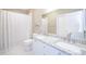 Bathroom with double sinks, granite counters and a shower/tub combination at 2114 Woodland Ln, Alpharetta, GA 30009