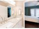 Bathroom with double sinks, granite counters and access to the bedroom at 2114 Woodland Ln, Alpharetta, GA 30009