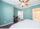 Bedroom features a ceiling fan, dark floors and an ensuite bathroom at 2114 Woodland Ln, Alpharetta, GA 30009