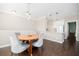 Dining area with dark floors, a round table and access to the kitchen area at 2114 Woodland Ln, Alpharetta, GA 30009