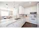 Bright kitchen with white cabinets, granite countertops, and stainless steel appliances, perfect for cooking and entertaining at 2114 Woodland Ln, Alpharetta, GA 30009