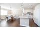 Bright kitchen features white cabinets, stainless appliances, an island and a breakfast nook at 2114 Woodland Ln, Alpharetta, GA 30009