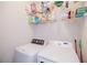 Functional laundry area with appliances, shelving, and ample space for organization and storage at 2114 Woodland Ln, Alpharetta, GA 30009