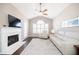 Inviting living room featuring a fireplace, vaulted ceiling, and large windows with white shutters, creating a bright space at 2114 Woodland Ln, Alpharetta, GA 30009