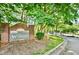 Community entrance sign for The Woodlands at Webb Bridge, a gated community at 2114 Woodland Ln, Alpharetta, GA 30009