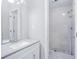 Bright bathroom with a vanity featuring white cabinetry and a luxurious, tiled walk-in shower at 255 Northland Ridge Trl, Atlanta, GA 30342