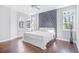 Bright bedroom boasts hardwood floors, ceiling fan, and stylish gray tufted headboard at 255 Northland Ridge Trl, Atlanta, GA 30342