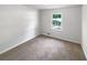 Neutral bedroom with soft carpet, white walls, and a window providing natural light at 3766 Windy Hill Se Dr, Conyers, GA 30013