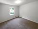 Cozy bedroom featuring neutral carpet, white walls, and a bright window offering natural light at 3766 Windy Hill Se Dr, Conyers, GA 30013