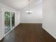 Open dining room featuring vaulted ceilings, sliding glass doors, and modern chandelier at 3766 Windy Hill Se Dr, Conyers, GA 30013
