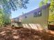 Exterior side view of home with wooden deck overlooking treed lot at 3766 Windy Hill Se Dr, Conyers, GA 30013