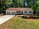 Charming single-story home with a manicured lawn and a three-car attached garage at 3766 Windy Hill Se Dr, Conyers, GA 30013