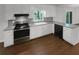 Well-lit kitchen featuring stainless steel appliances and white cabinetry at 3766 Windy Hill Se Dr, Conyers, GA 30013