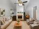 Bright living room with vaulted ceiling, brick fireplace, and stylish neutral furniture at 3766 Windy Hill Se Dr, Conyers, GA 30013