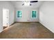 Bright main bedroom featuring plush carpeting and two windows providing natural light at 3766 Windy Hill Se Dr, Conyers, GA 30013