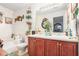 Bathroom featuring double sinks, updated vanity, and separate tub at 6664 Saint Jude Dr, Fairburn, GA 30213