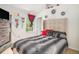 This bedroom features a high ceiling, decor, and a window, with neutral walls and a large decorative headboard at 6664 Saint Jude Dr, Fairburn, GA 30213