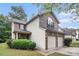 A charming home with a brick front, a two-car garage, and beautiful green landscaping at 6664 Saint Jude Dr, Fairburn, GA 30213