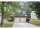 Charming two-story home with a two-car garage and well-maintained landscaping at 6664 Saint Jude Dr, Fairburn, GA 30213