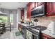 Well-equipped kitchen with gas range, tiled backsplash, and ample counter space at 6664 Saint Jude Dr, Fairburn, GA 30213