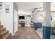 Open-concept living room features neutral colors, a fireplace, and a ceiling fan at 6664 Saint Jude Dr, Fairburn, GA 30213